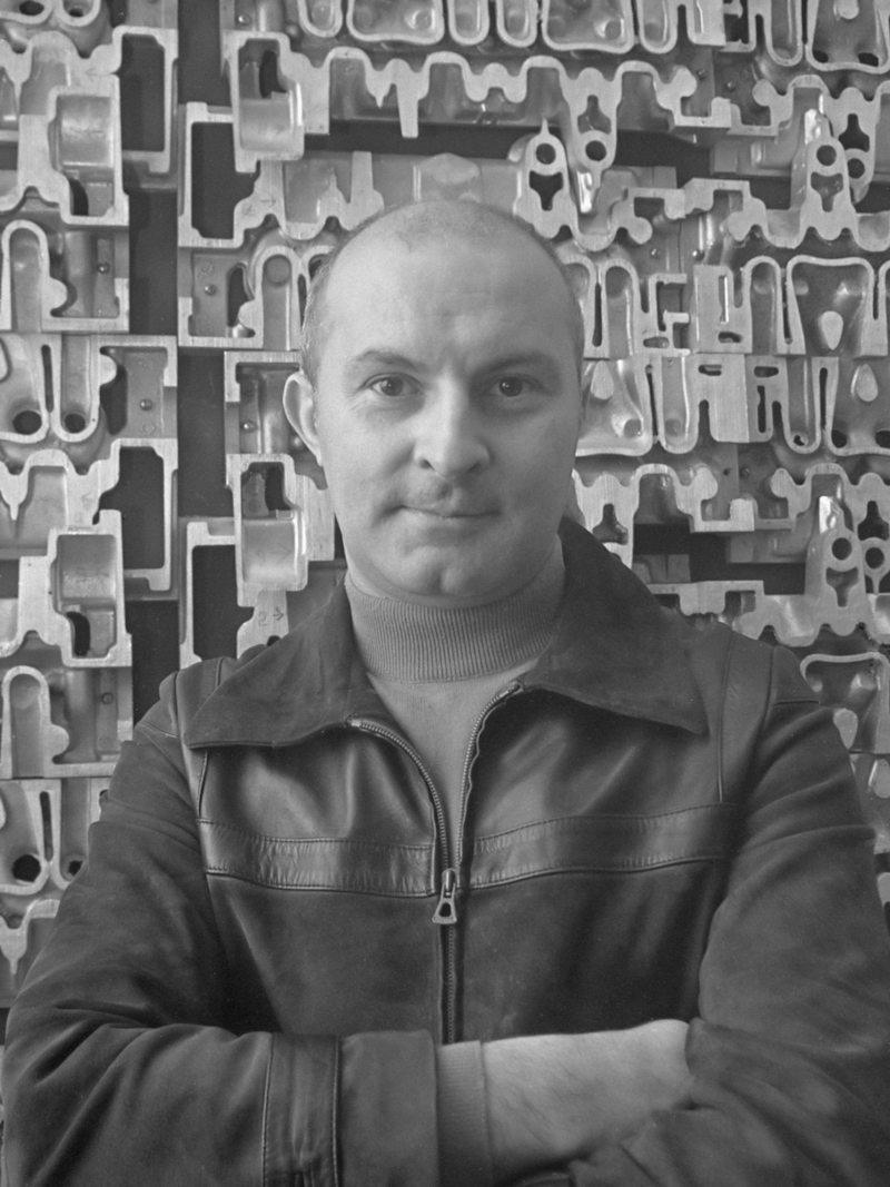 Arman in front of one of his Accumulations at Stedelijk Museum in 1969